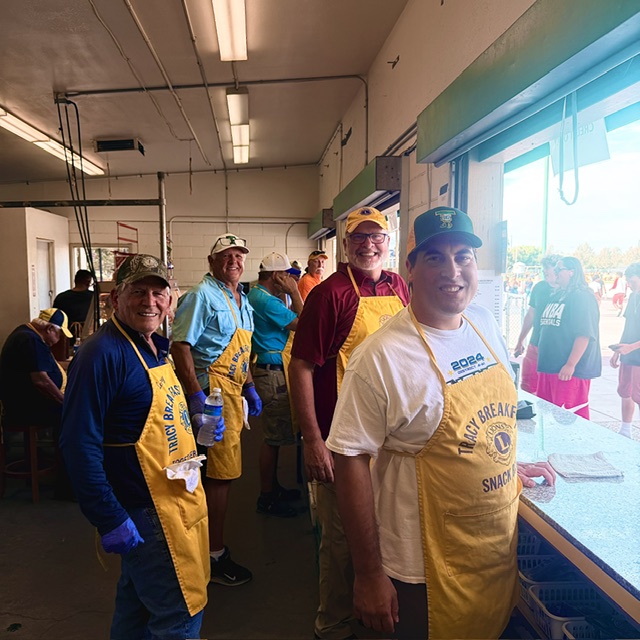 Tracy Breakfast Lions Club volunteers working together inside the Tracy High snack bar.